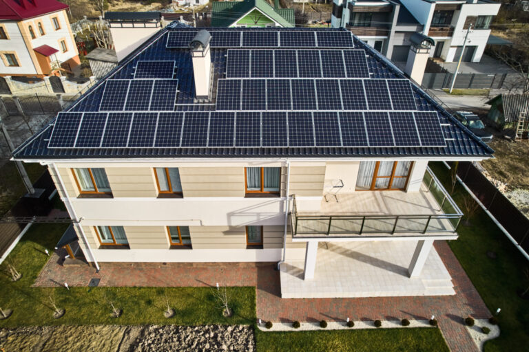 Autonomous house with solar modules for generating electricity through photovoltaic effect. New home with solar panel system on roof. Ecological renewable energy sources concept.